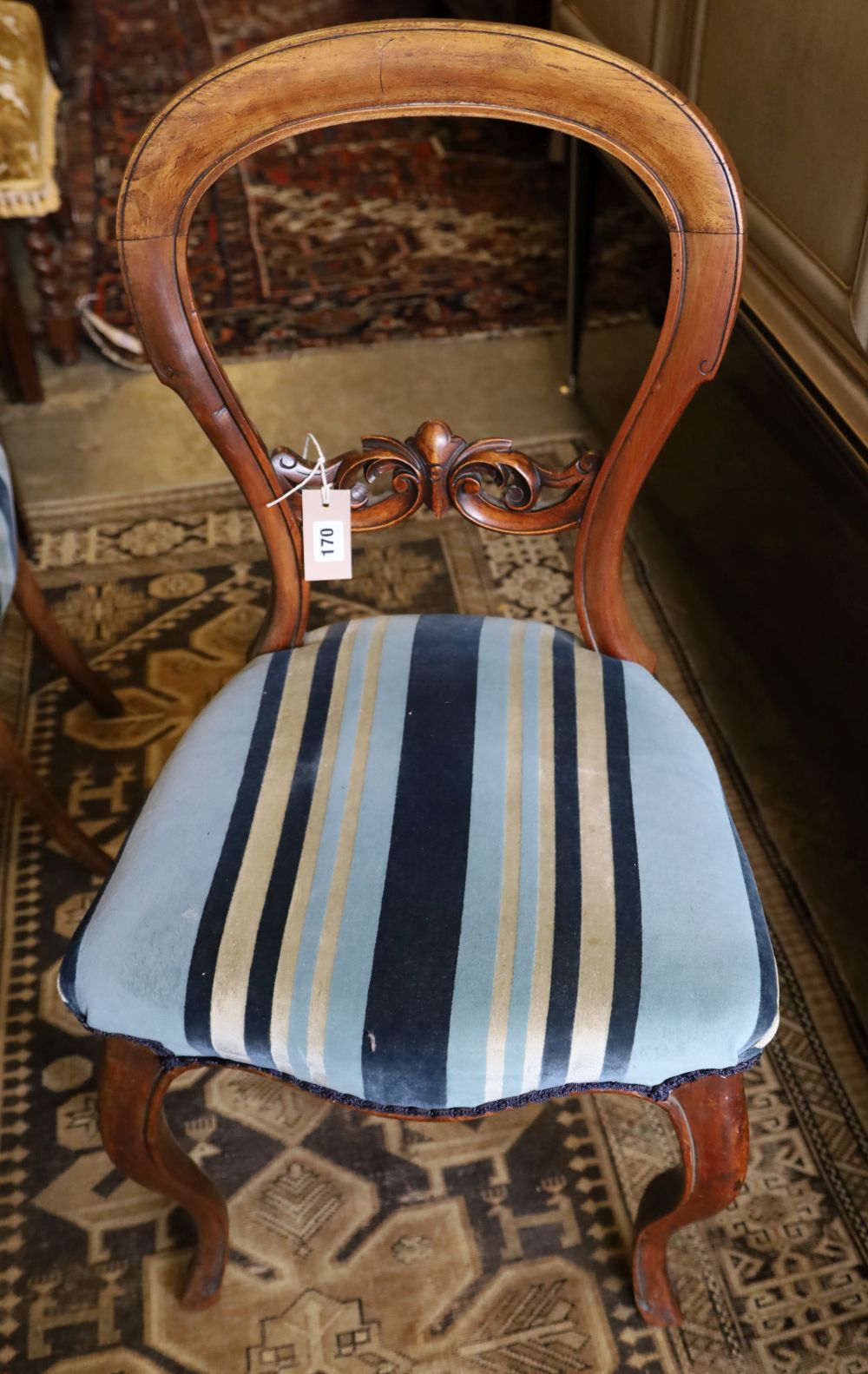 A set of four Victorian walnut balloon-back chairs